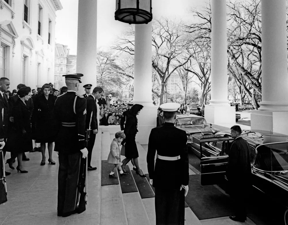 Jacqueline Kennedy, walks down the steps with her children towards a car, prior to the funeral procession of President John F. Kennedy.