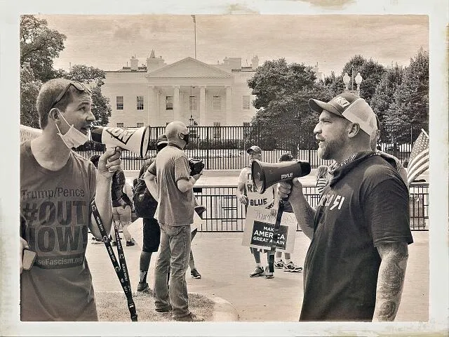 Photograph of an Anti-Trump protestor and a Pro-Trump protestor face-off with megaphones, White House, Washington, DC